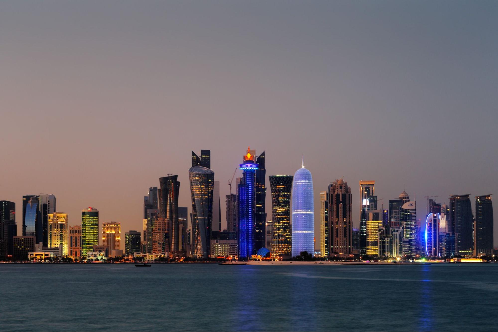 Doha, Qatar at Dusk is a beautiful city skyline of impressive contemporary architecture